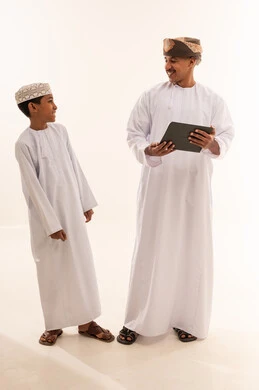 Omani Man and Boy Using Tablet in Studio