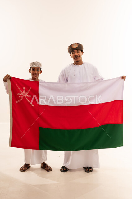 Omani Man and Boy Holding Oman National Flag