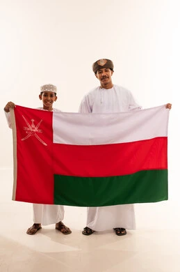 Omani Man and Boy Holding Oman National Flag