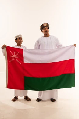 Omani Man and Boy Holding Oman National Flag
