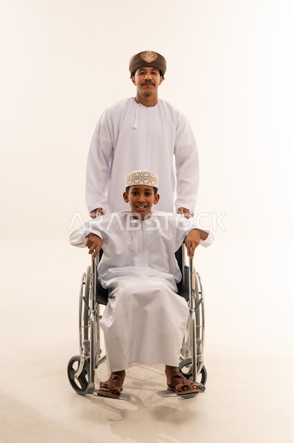 Omani Man and Boy in Wheelchair on White Background