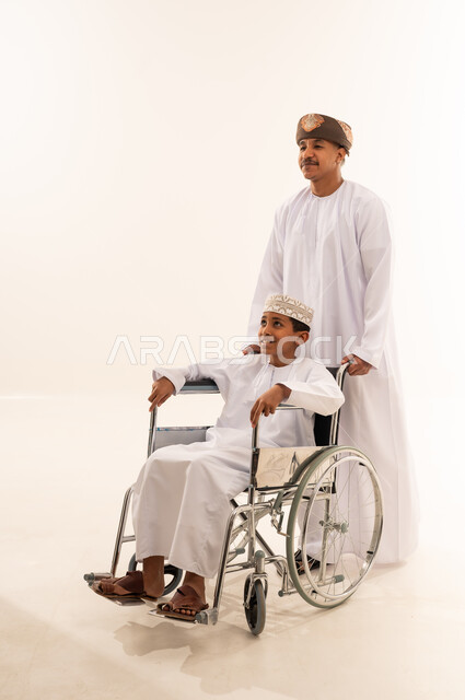 Omani Man and Boy in Wheelchair on White Background