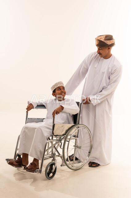 Omani Man and Boy in Wheelchair Studio Shot