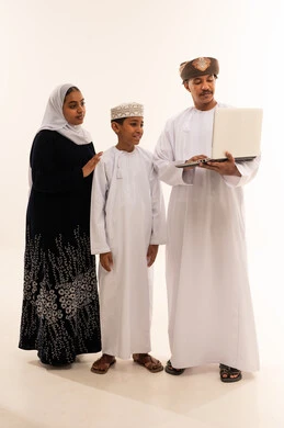 Omani Family Looking at Laptop on White Background