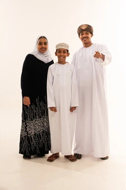 Omani Family in Traditional Dress Pointing at Camera