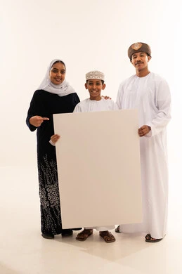 Omani Family Holding Blank Board in Traditional Dress