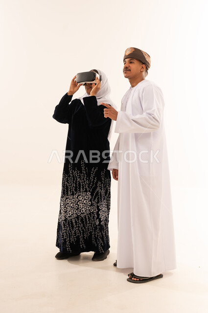 Omani Couple Using VR Headset in White Studio