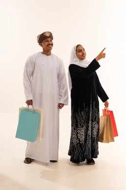 Omani Couple with Shopping Bags in Studio