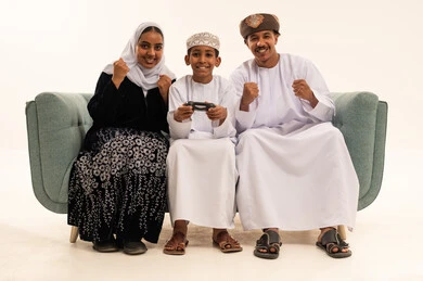 Omani Family Celebrating Video Game Win Indoors