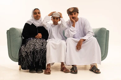 Omani Family in Traditional Dishdasha on White Background