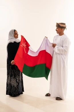 Omani Man and Woman Holding Oman National Flag