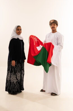 Omani Man and Woman Holding National Flag in Studio