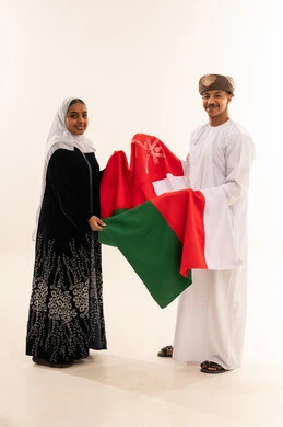 Omani Man and Woman Holding National Flag in Studio