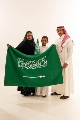 Saudi Family Holding National Flag on White Background