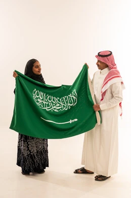 Saudi Man and Woman Holding National Flag