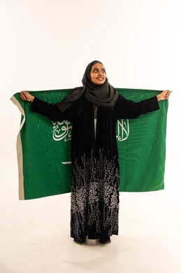 Saudi Woman Holding Saudi Arabia Flag on White Background