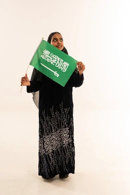 Saudi Woman Holding KSA Flag on White Background