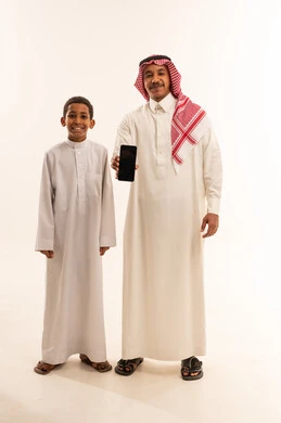 Saudi Man and Son Holding Smartphone on White Background