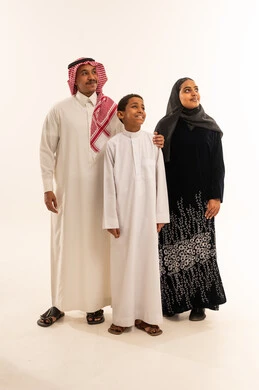 Saudi Family in Traditional Clothing Looking Upwards