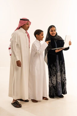 Saudi Family Looking at Laptop on White Background