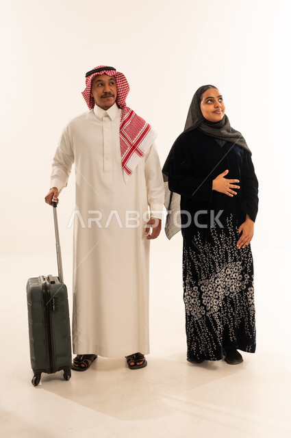 Saudi Couple with Suitcase Traveling in Studio