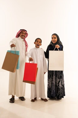 Saudi Family Holding Shopping Bags on White Background