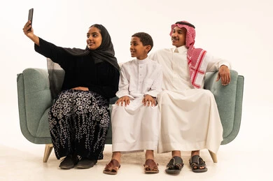 Saudi Family Taking Selfie with Smartphone in Studio