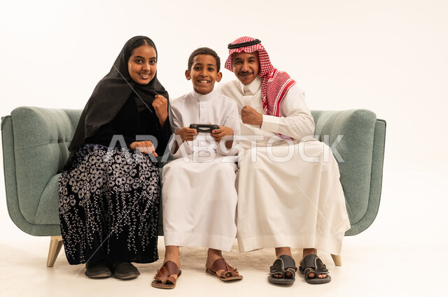 عائلة سعودية تلعب ألعاب الفيديو بخلفية بيضاء
