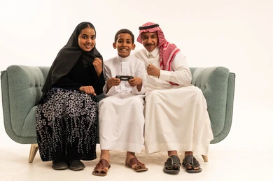 Saudi Family Playing Video Games on White Background