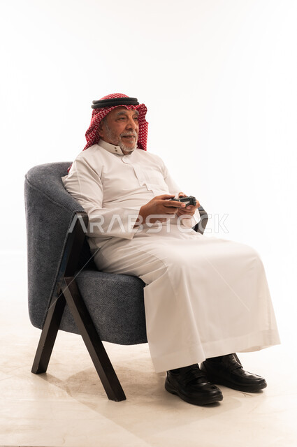 Elderly Saudi Man Holding Game Controller on White Background