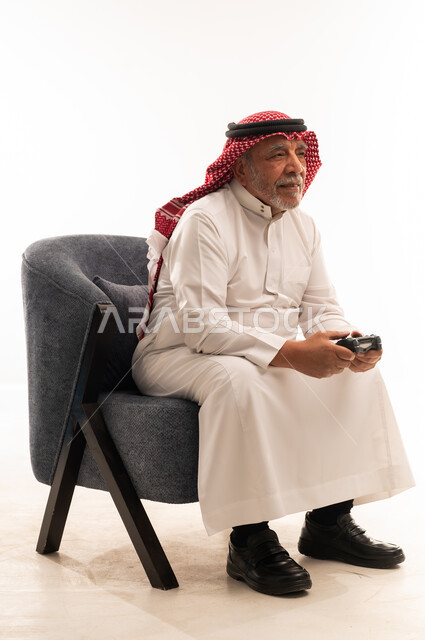 Elderly Saudi Man Holding Video Game Controller