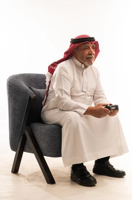 Elderly Saudi Man Holding Video Game Controller