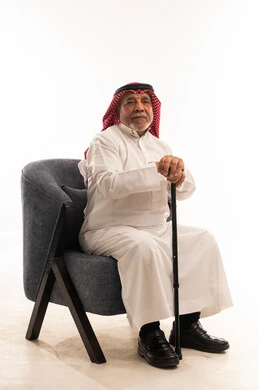 Senior Saudi Man in Traditional Thobe with Walking Stick