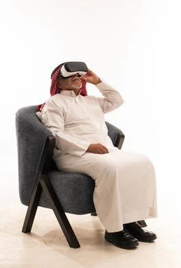 Saudi Elderly Man Using VR Headset in White Studio
