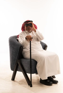 Elderly Saudi Man with Binoculars and Walking Cane