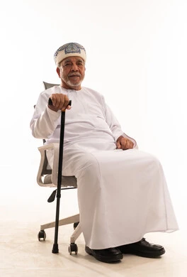 Elderly Omani Man in Traditional Dress with Cane