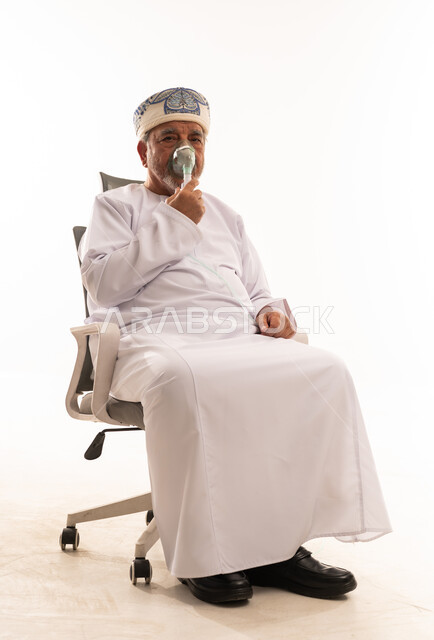 Elderly Omani Man Using Oxygen Mask in Studio