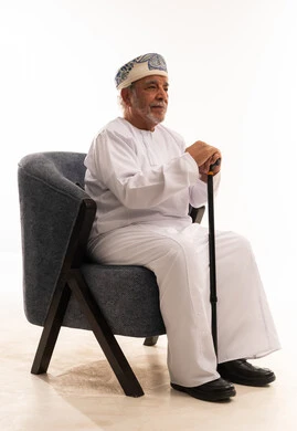 Elderly Omani Man in Traditional Dress with Cane