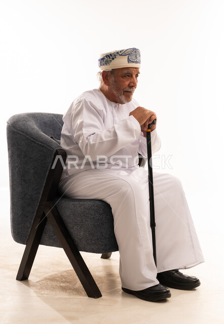 Elderly Omani Man in Traditional Dress with Cane