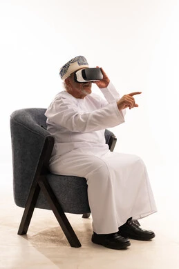 Omani Senior Man Using VR Headset on White Background
