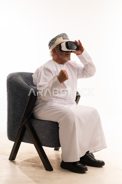 Senior Omani Man Using VR Headset on White Background