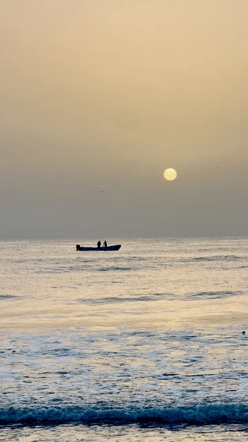 Fishing Boat in Oman at Sunset on Calm Ocean