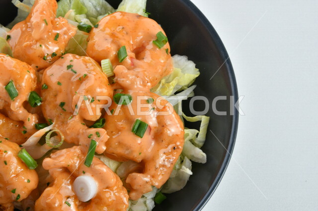 Close-up of a plate of delicious shrimp with different flavors of sauce, a plate of delicious appetizers, white background, fast food, Arabic restaurants, delicious seafood