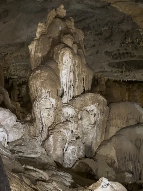 منظر داخلي لكهف الهوته في سلطنة عمان يظهر التكوينات الصخرية الطبيعية والممرات المضاءة في أجواء جيولوجية مذهلة.