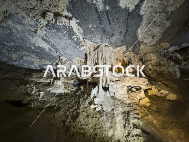 منظر داخلي لكهف الهوته في سلطنة عمان يظهر التكوينات الصخرية الطبيعية والممرات المضاءة في أجواء جيولوجية مذهلة.