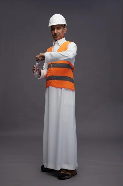 Saudi Worker in Safety Gear Holding Water Bottle