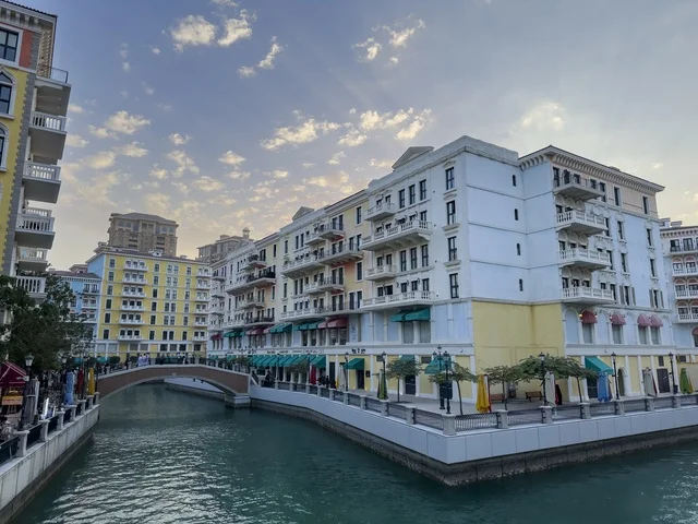 Qanat Quartier canal at The Pearl in Doha showcasing luxury buildings and beautiful reflections on the water. doha.Qatar - February 15 2026 .