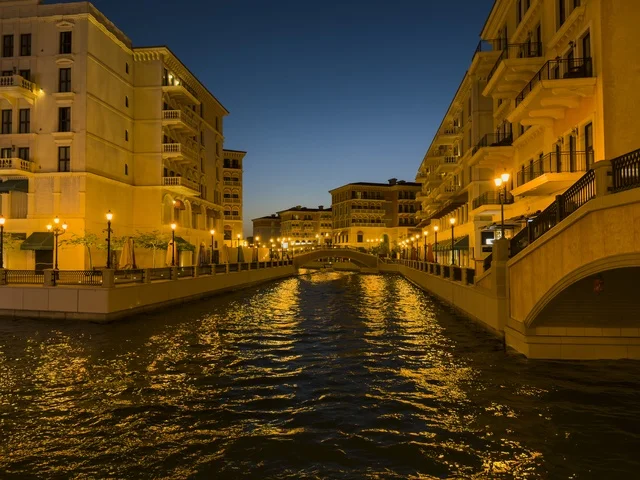 Qanat Quartier canal at The Pearl in Doha showcasing luxury buildings and beautiful reflections on the water. doha.Qatar - February 15 2026 .