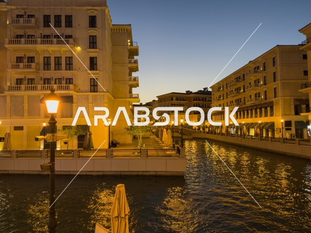 Qanat Quartier canal at The Pearl in Doha showcasing luxury buildings and beautiful reflections on the water. doha.Qatar - February 15 2026 .