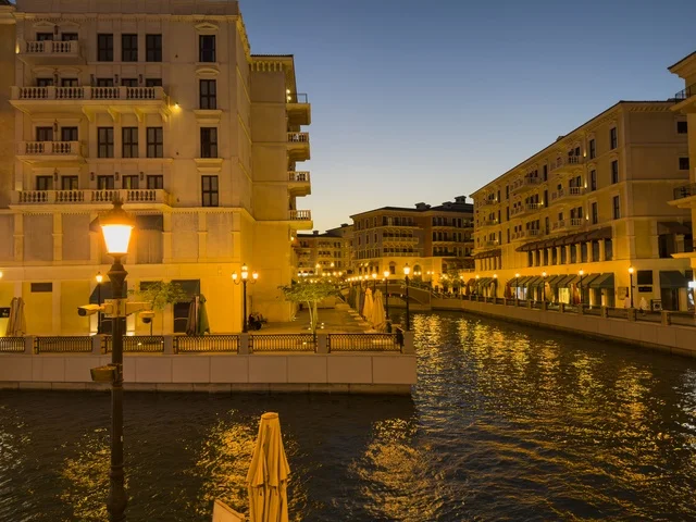 Qanat Quartier canal at The Pearl in Doha showcasing luxury buildings and beautiful reflections on the water. doha.Qatar - February 15 2026 .